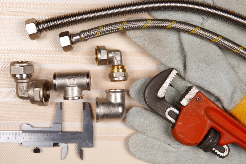 Plumber working on pipes in a Edgware home